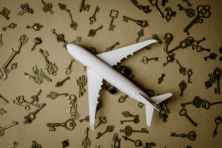 Model airplane and pile of key - for success and business backgroundの写真素材