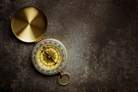 Old compass on old metal floor.の写真素材