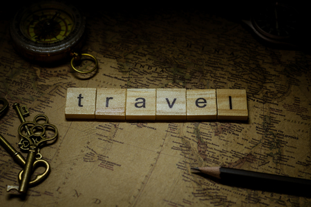 travel wooden alphabet on antique map. - advertising backgroundの写真素材