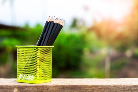 black pencil in green basket in the morning.の写真素材