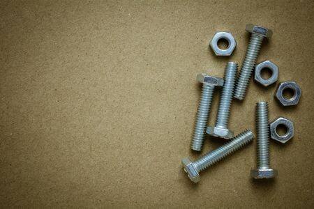 nuts and bolts on abandoned paper. - for diy or construction concept background.の写真素材