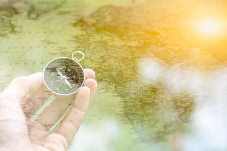 compass in the hand front a antique map.の写真素材