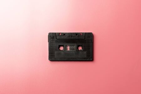black tape cassette on pink background.の写真素材