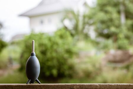 blue blower rubber on a wooden table. - vintage style.の写真素材