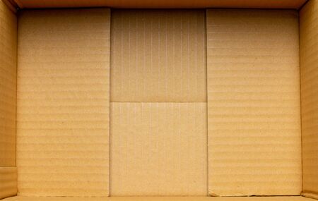 Inside a empty cardboard packaging box.