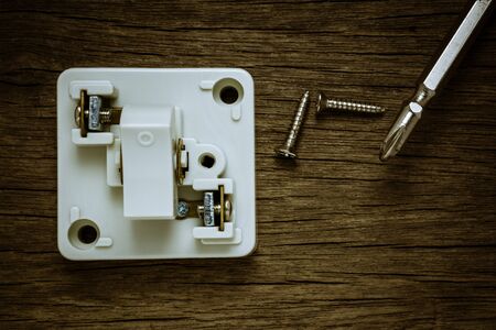 white lighting switch on old wood wall.の写真素材
