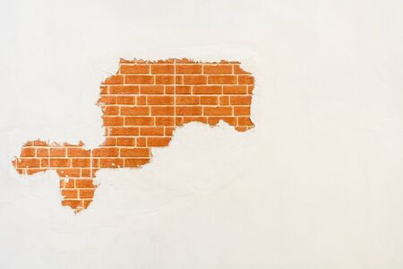 Old brick wall with peeling plaster.の写真素材