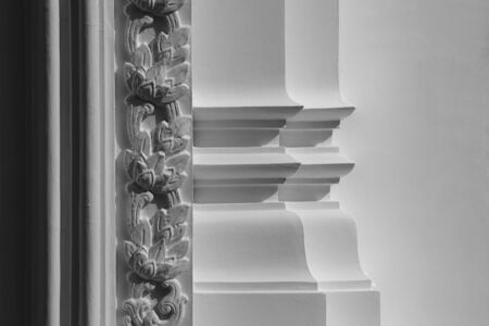 line and flower pattern of low relief sculpture at white concrete wallの写真素材