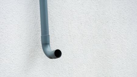 curved plastic pipe at white wallの写真素材