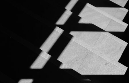 Abstract background of shadows from the window at the staircase. - monochrome
