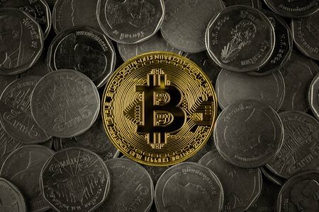 golden bitcoins on pile of many coins.の写真素材