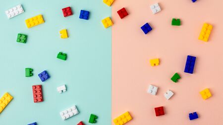 Plastic building blocks on blue and pink backgroundの写真素材