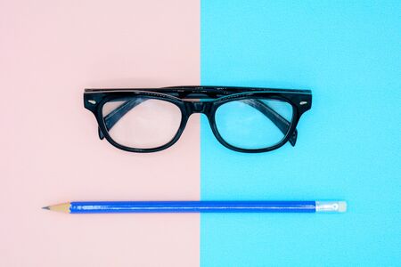 black glasses on blue and pink backgroundの写真素材