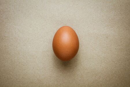 Brown chicken egg on recycled craft paperの写真素材