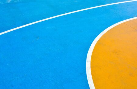 closeup blue and yellow basketball courtの写真素材