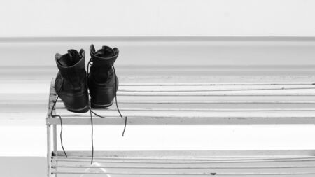 Black leather military boots on shoes shelf