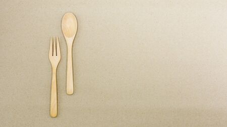 Wooden spoon and fork on brown paper - backgroundの写真素材