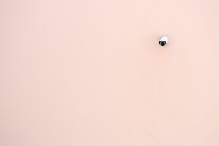 CCTV Camera at the pink concrete wall