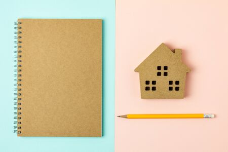 brown wood home icon and a diary on blue and pink backgroundの写真素材
