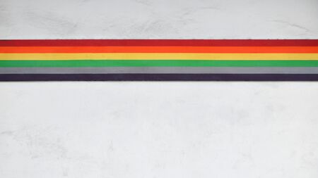 painted of a rainbow at the old white concrete wall