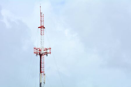 Cellular antenna against blue sky in summer