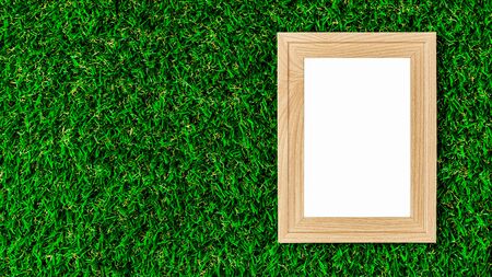 Classic wooden photo frame on green lawn.の写真素材