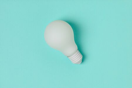 white light bulb on blue backgroundの写真素材
