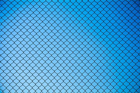 Wire mesh steel on blue sky backgroundの写真素材