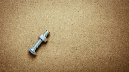nuts and bolts on abandoned paper. - for diy or construction concept background.の写真素材