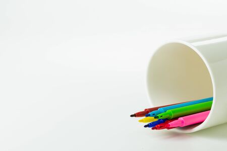 colorful of color pen in white ceramic coffee cup.の写真素材