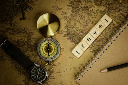 Nonthaburi, Thailand - June 8, 2018: wooden alphabet words "travel" and compass on old map background. - for yourself concept.の写真素材