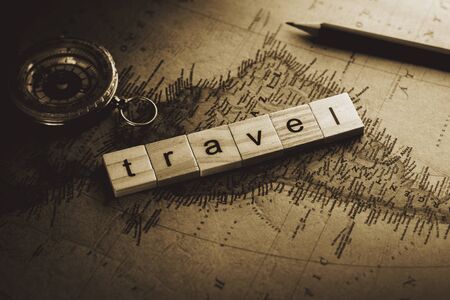 travel wooden alphabet on antique map. - advertising backgroundの写真素材