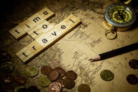 wooden alphabet words "time to travel" on old map background.  - for yourself concept.の写真素材
