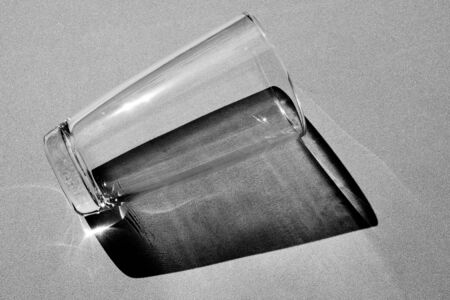Glass of water with shadow - monochrome