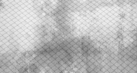 shadow of cage at old cement wallの写真素材