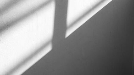 Abstract background of a white wall with shadows from the window.の写真素材
