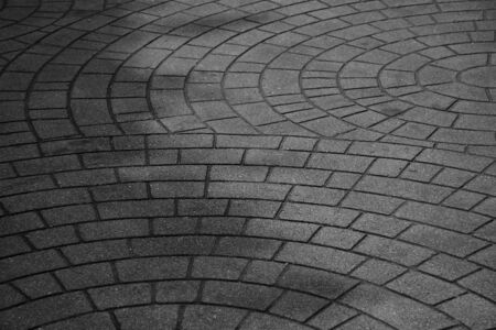 patterned paving tiles, old cement brick floor - monochrome backgroundの写真素材