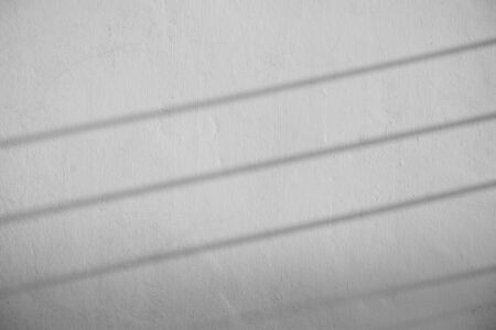 shadow of wire on old cement wall - monochromeの写真素材