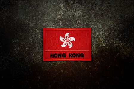 hong kong flag on rusty abandoned metal floor in the dark.