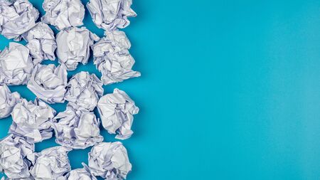 pile of a white crumpled paper balls on blue background.の写真素材