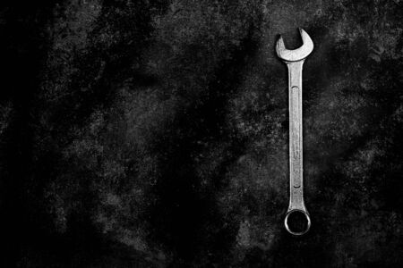 a spanner on old abandoned iron plate. - industrial workshop hand tools concept.の写真素材