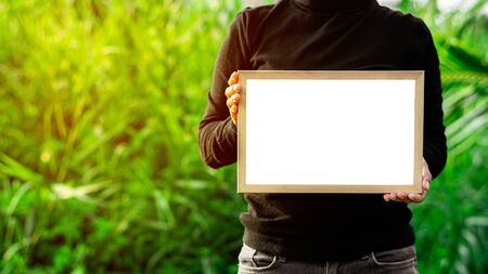 women's hands holding white blank advertisement card with copy space.