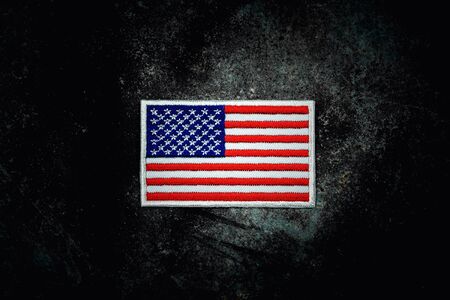 american flag on rusty abandoned metal floor in the dark.の写真素材
