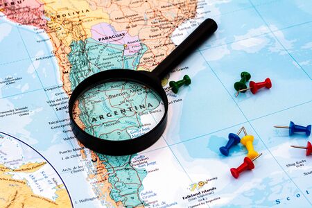 magnifying glass on the world map selective focus at argentina. - economic and business concept.の写真素材