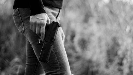 woman holding a gun in hand. - violence and crime concept.の写真素材