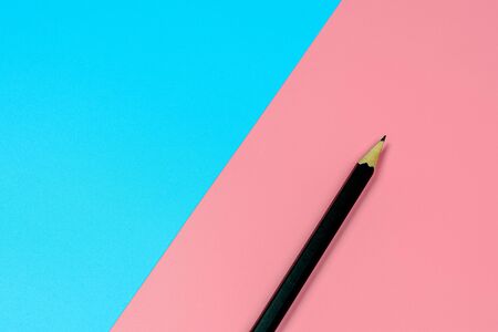 a pencil on blue and pink background with copy space. - top view.の写真素材