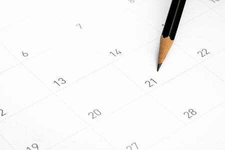 The pencil points to the 21 in the calendar.の写真素材