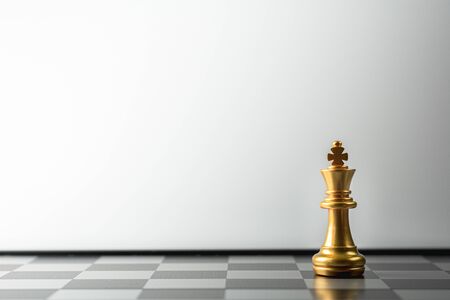 lonely golden king chess standing on chess board.