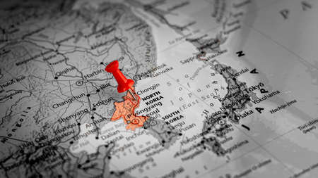 red pin placed selective at north korea. - economic and government concept.