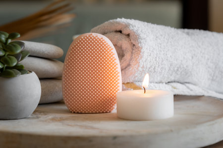 Facial cleansing brush and massager, towel and candle, skin care beauty concept, horizontal banner with free space for text. High quality photoの写真素材
